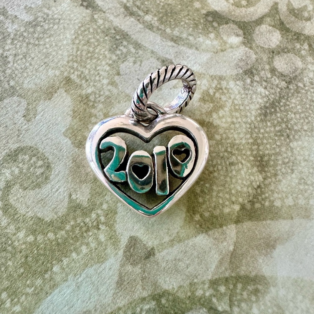 Brighton silver  “2010” with hearts charm. Like new.
